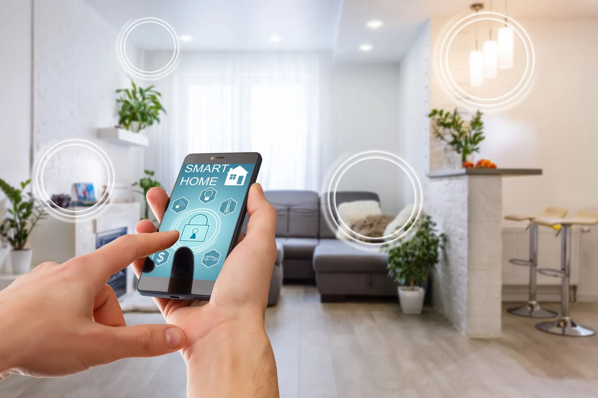 Smart home technology interface on smartphone app screen with augmented reality (AR) view of internet of things (IOT) connected objects in the apartment interior, person holding device.jpg